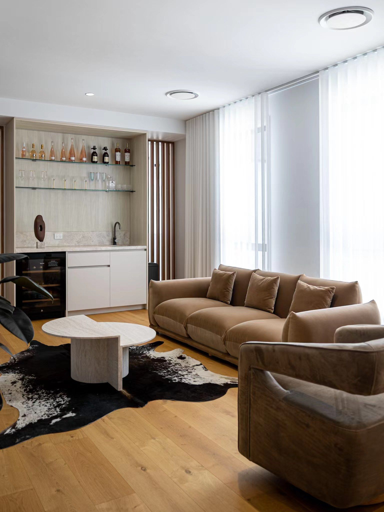 A living room with a couch and two chairs