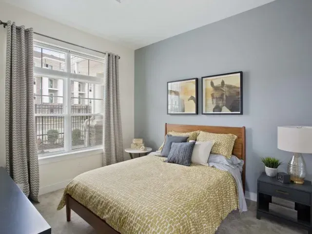 Corsa Tuscan Village apartment bedroom with oversized window. 
