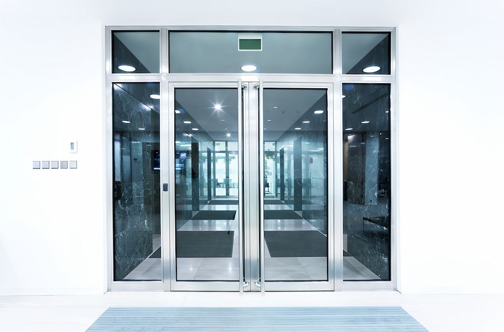 A Large Glass Door In A Building With A Lot Of Windows — Reef Electrical in Cannonvale, QLD