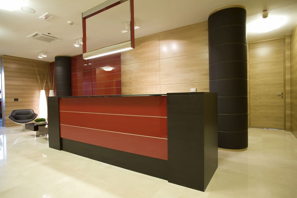 A Red And Black Reception Desk In A Lobby — Reef Electrical in Cannonvale, QLD