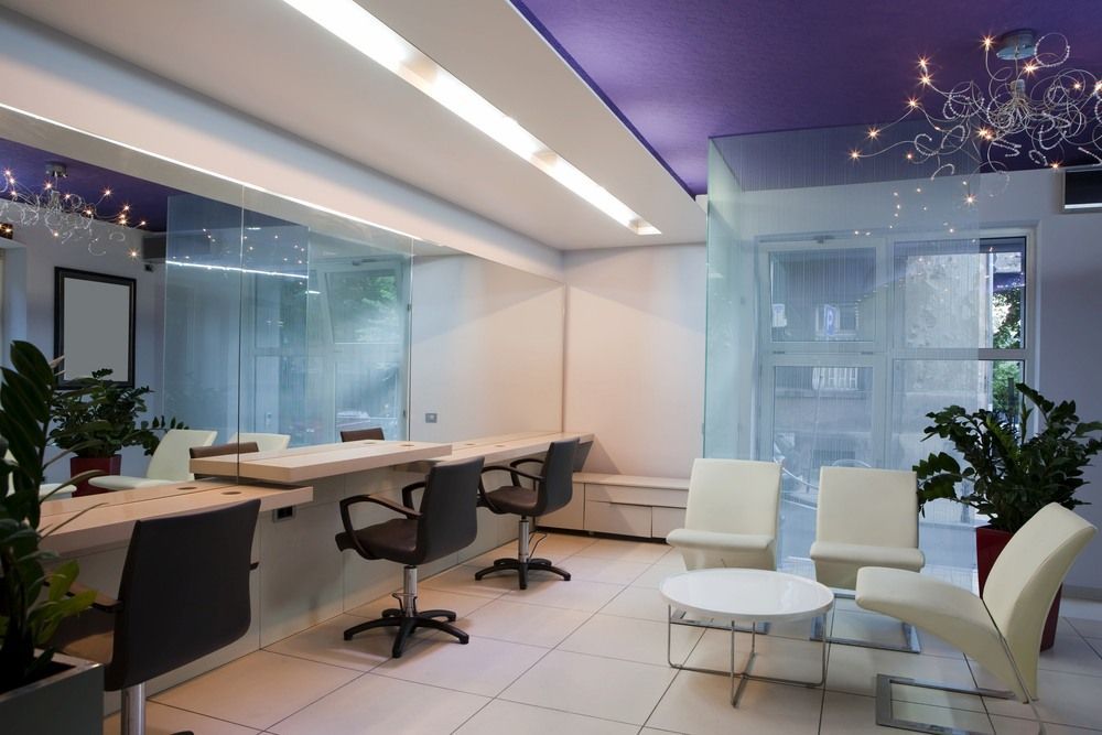 A Salon With A Purple Ceiling And White Chairs — Reef Electrical in Proserpine, QLD