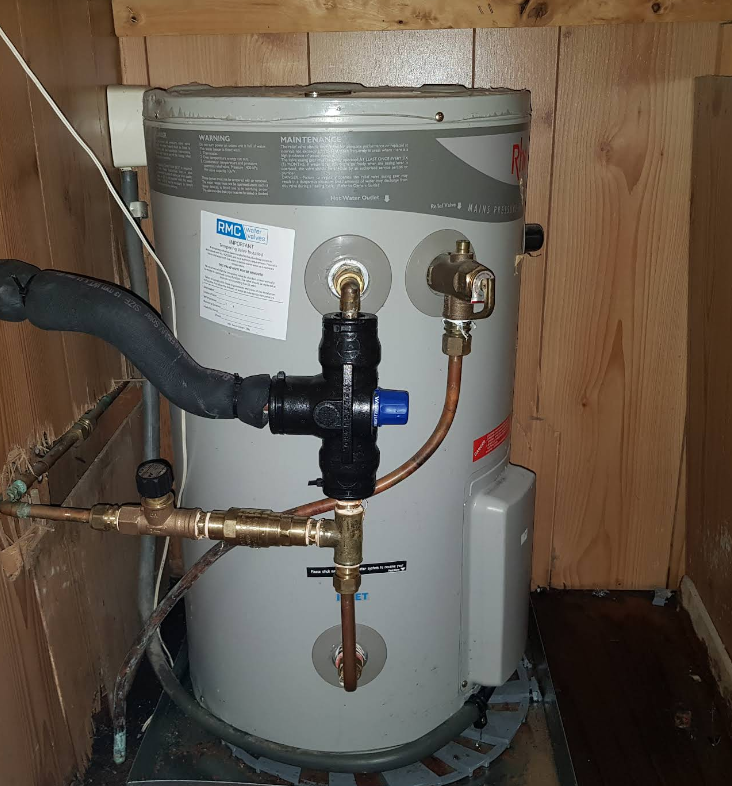 A Water Heater Is Sitting In A Room Next To A Boiler — Jobs2BDone in Pearl Beach, NSW