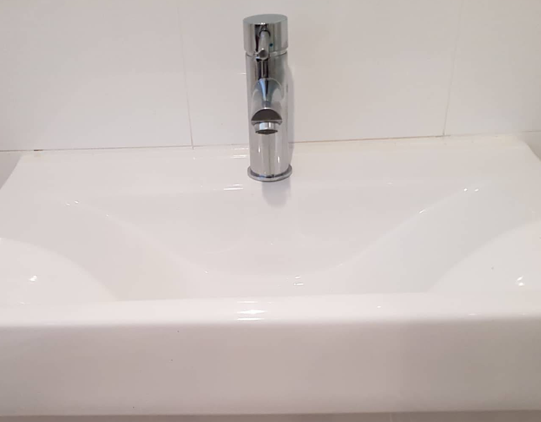 A Close Up Of A Kitchen Sink With A Chrome Faucet — Jobs2BDone in Avoca Beach, NSW