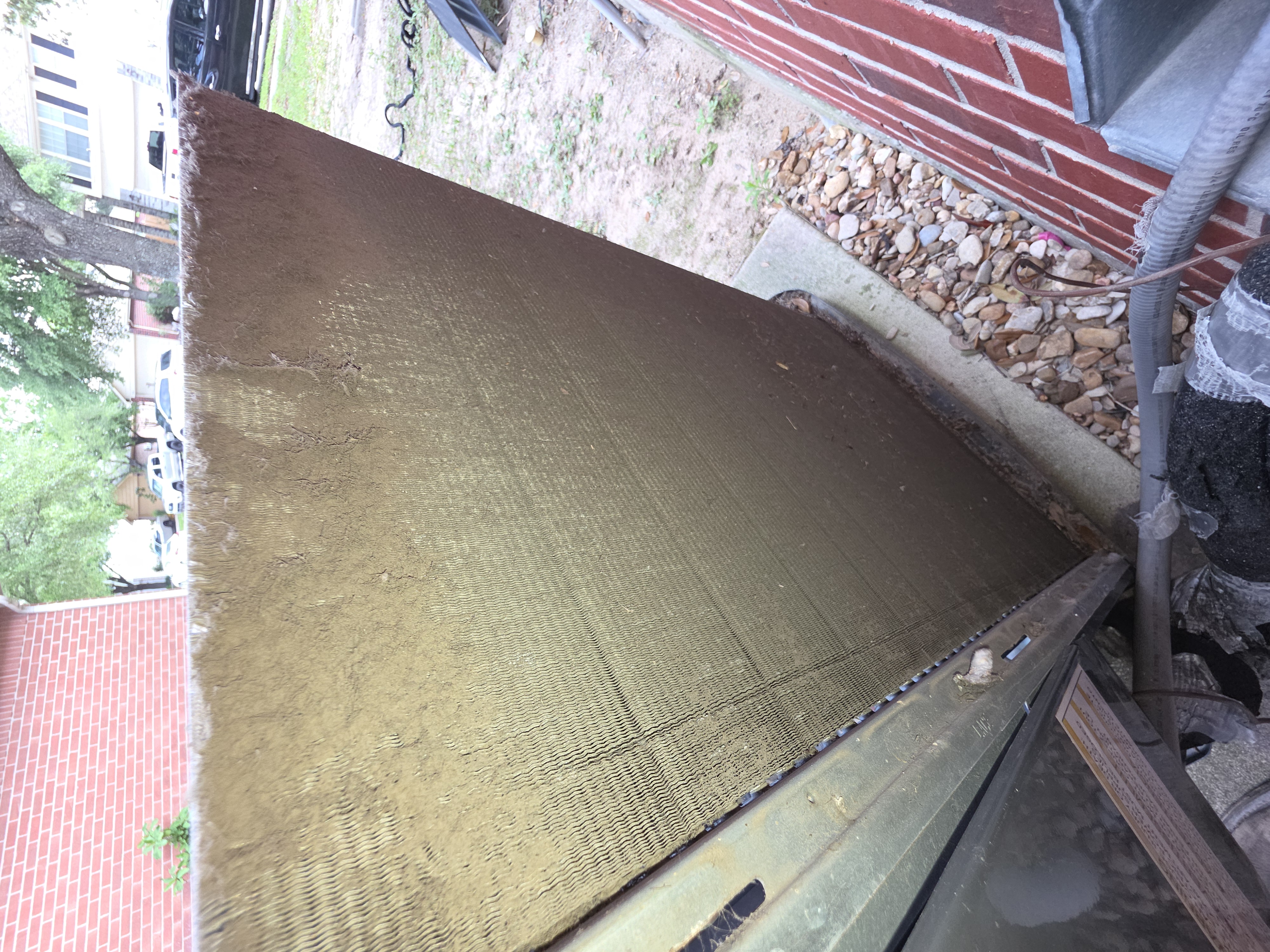 Open HVAC unit with exposed circuit boards, wiring, and components inside the outdoor cabinet