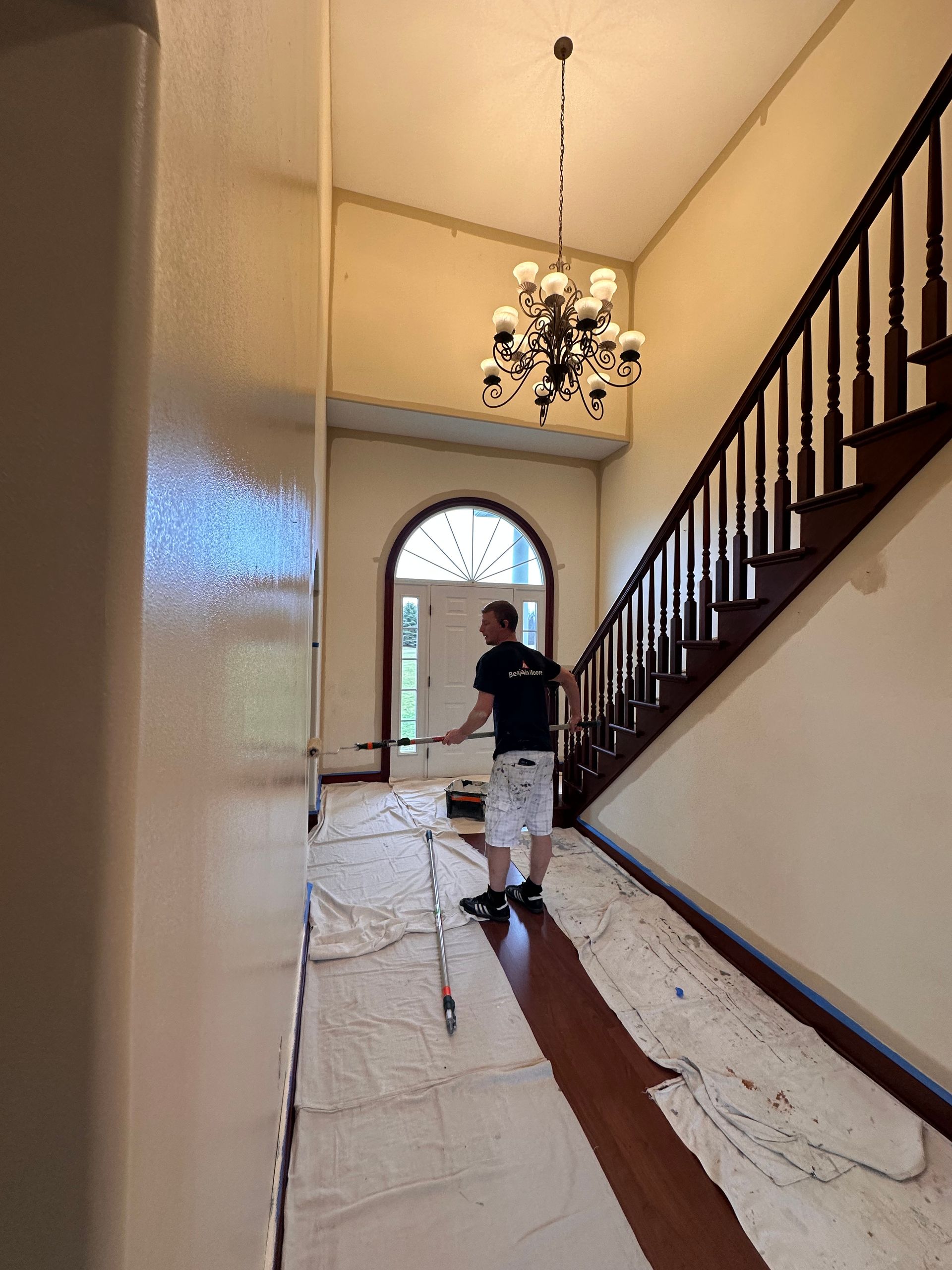 Professional painter rolling paint on a foyer wall in Bath Ohio by Inspired Services & Painting