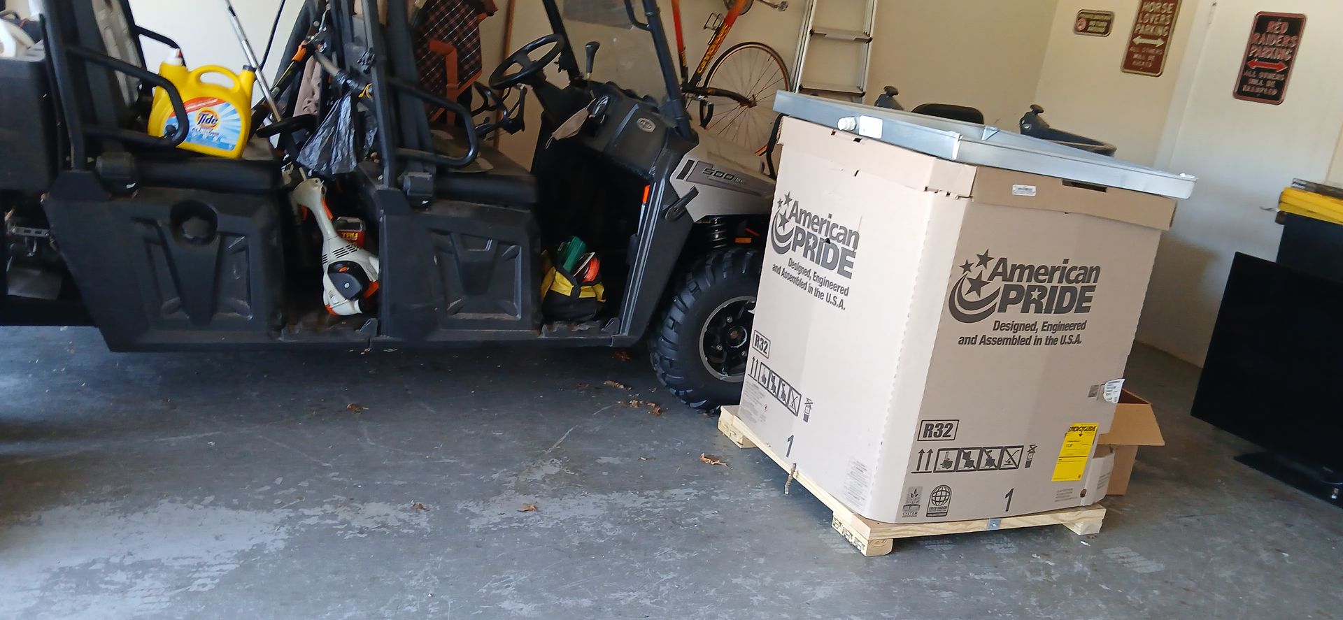 Garage with a forklift, a white pallet box, and tools inside a workshop.