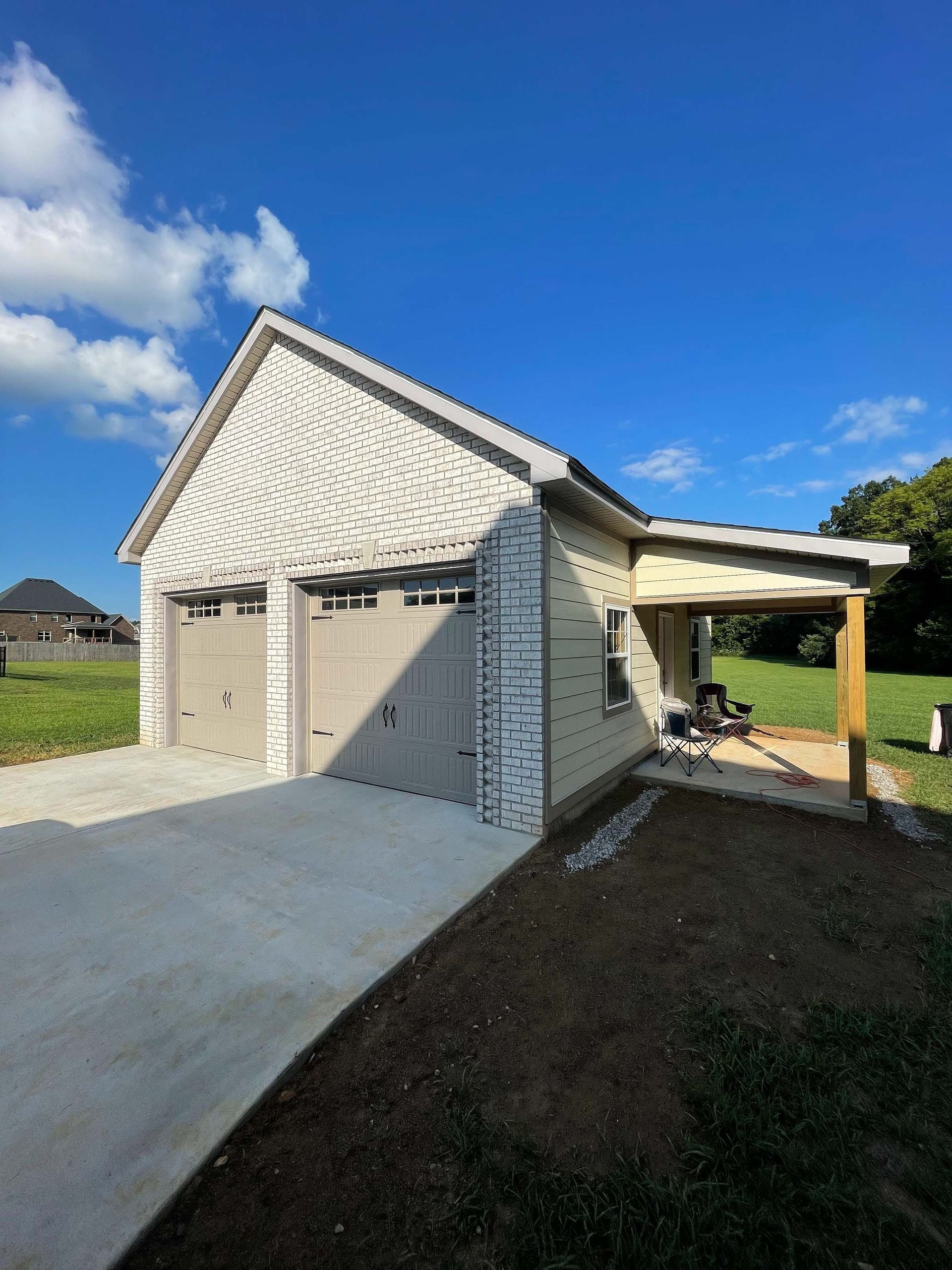 A small house with a garage and a covered porch