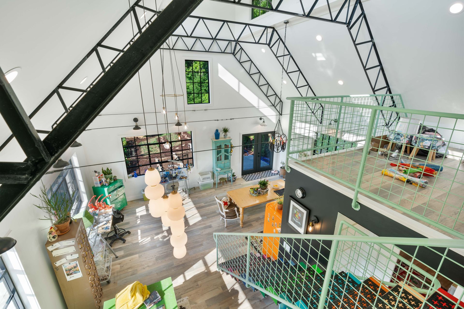 An aerial view of a large room with a green railing.