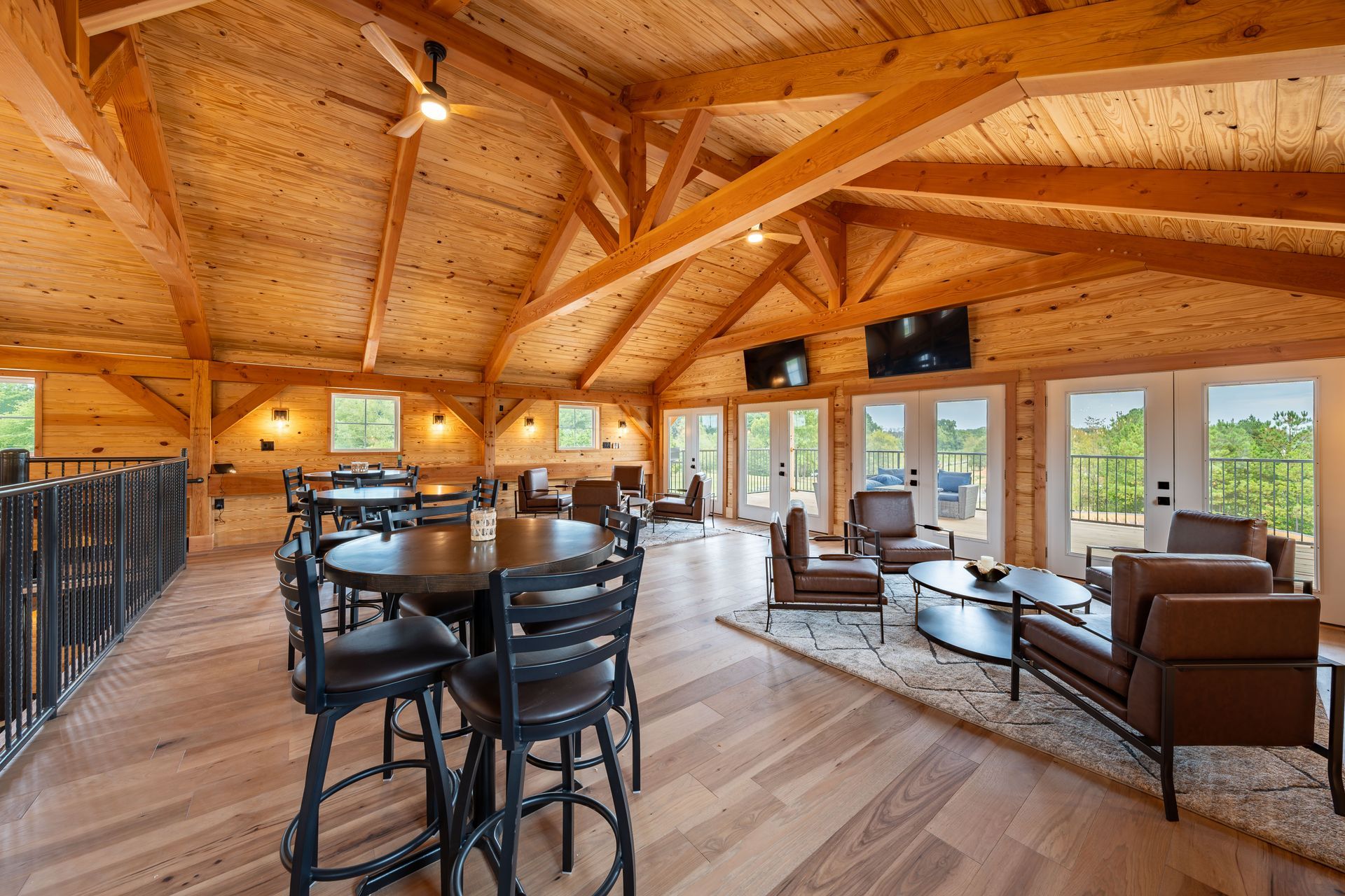 A large wooden room with tables and chairs in it