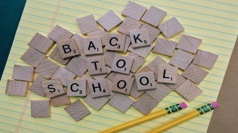 A pile of scrabble tiles with the words back to school written on them