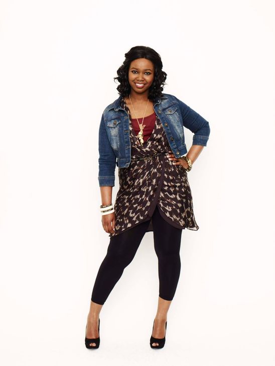 A woman realtor standing with a power pose.