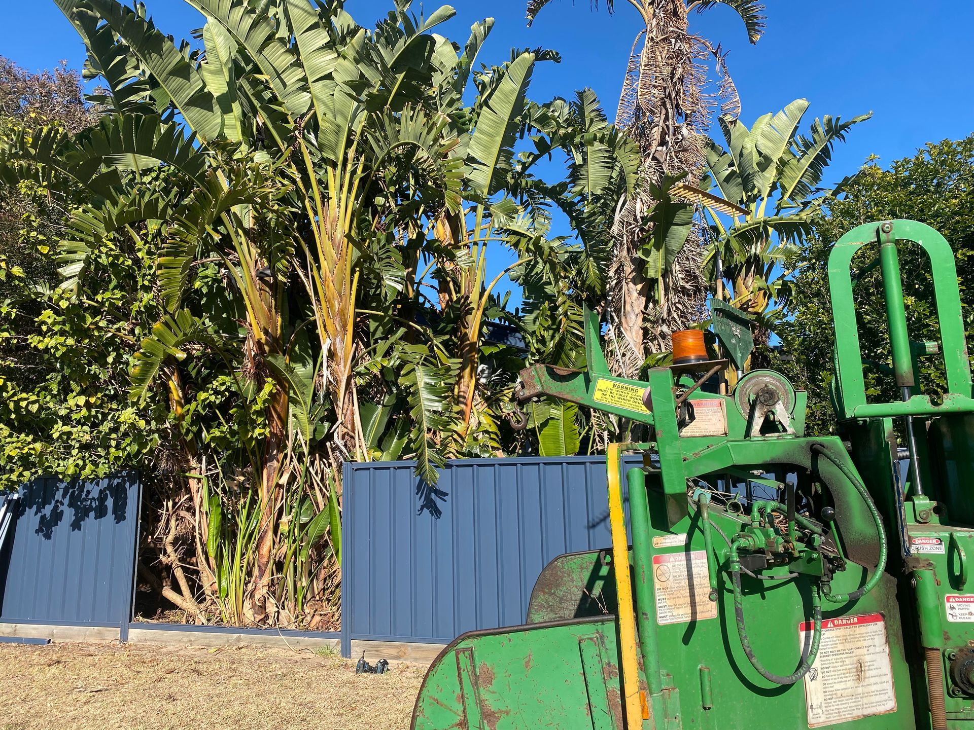 A Wheelbarrow Filled With Plants And A Watering Can In A Garden — Out On A Limb Tree and Garden Care In Broulee, NSW