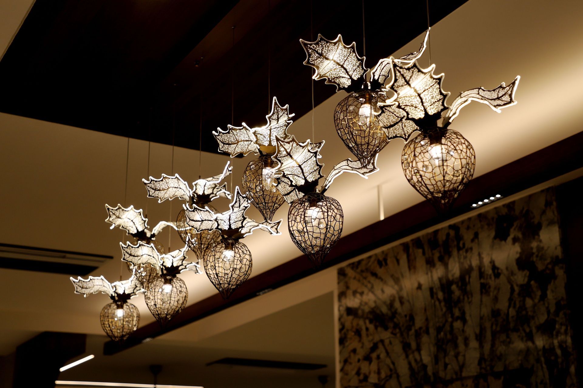 Decorative floral ceiling light fixture with warm glowing bulbs in a modern interior
