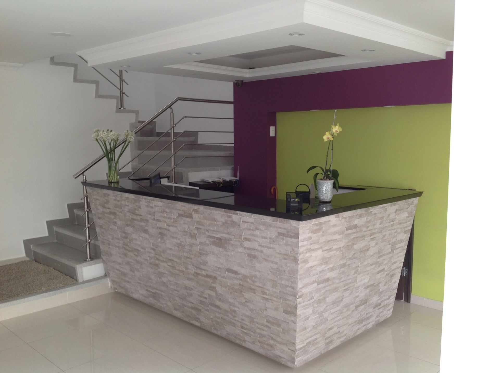 A large counter in a room with stairs in the background