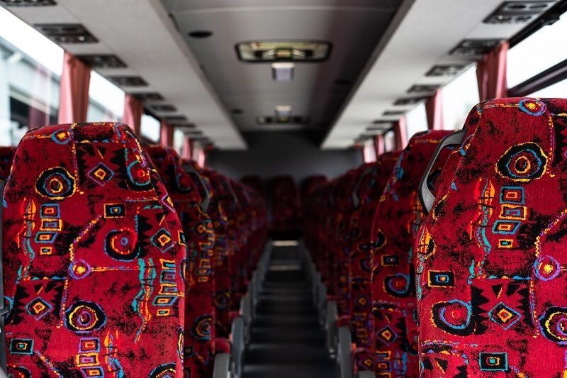 Interior of a Bus With Rows of Red Patterned Seats — J & B Bus and Coach Pty Ltd In South Murwillumbah, NSW