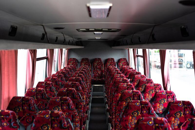 Empty Bus Interior With Rows of Red Patterned — J & B Bus and Coach Pty Ltd In South Murwillumbah, NSW