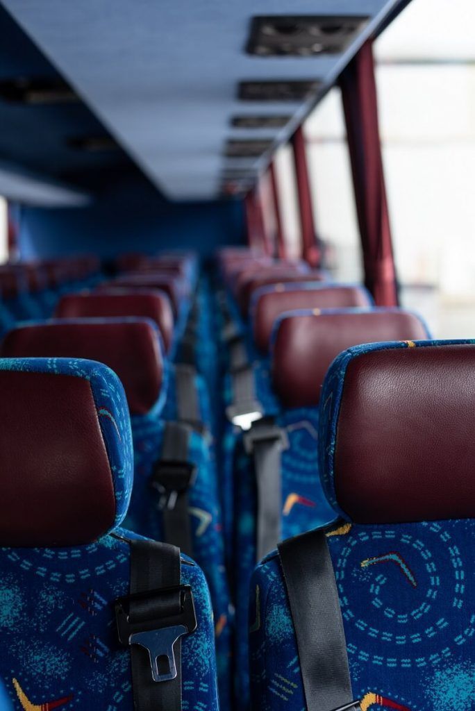 Empty Bus Interior With Blue Patterned Seats — J & B Bus and Coach Pty Ltd In Byron Bay, NSW