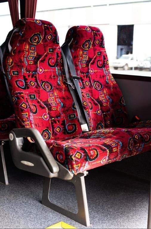 Red Patterned Bus Seats by a Window — J & B Bus and Coach Pty Ltd In Ballina, NSW