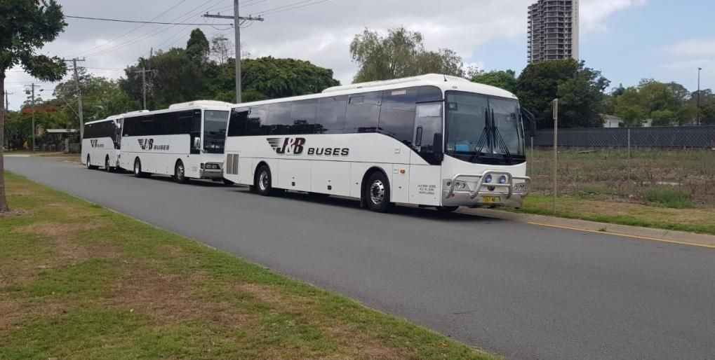 Two White Coaches Parked on a Road — J & B Bus and Coach Pty Ltd In Ballina, NSW