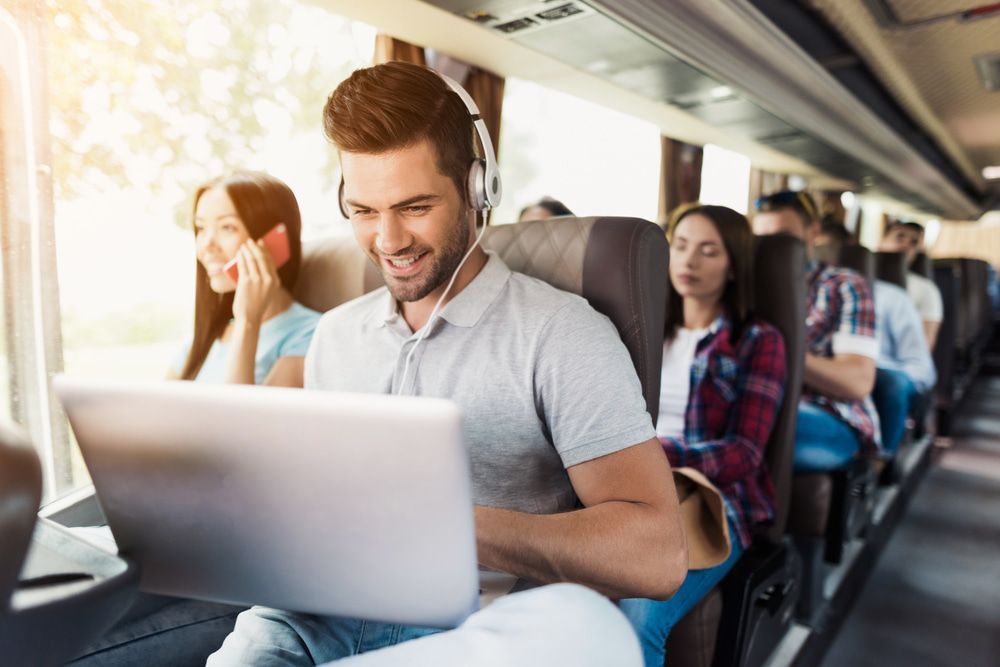 Passenger Using a Laptop on a Train — J & B Bus and Coach Pty Ltd In South Murwillumbah, NSW