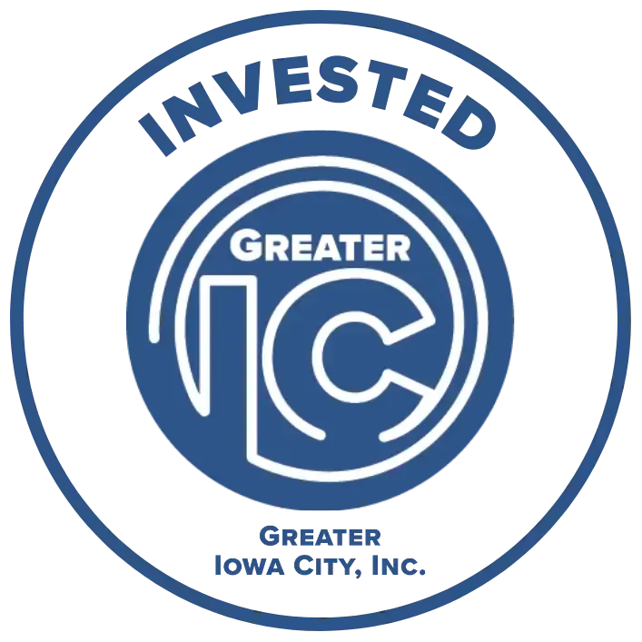Blue circular logo reading “Invested Greater IC” and “Greater Iowa City, Inc.”