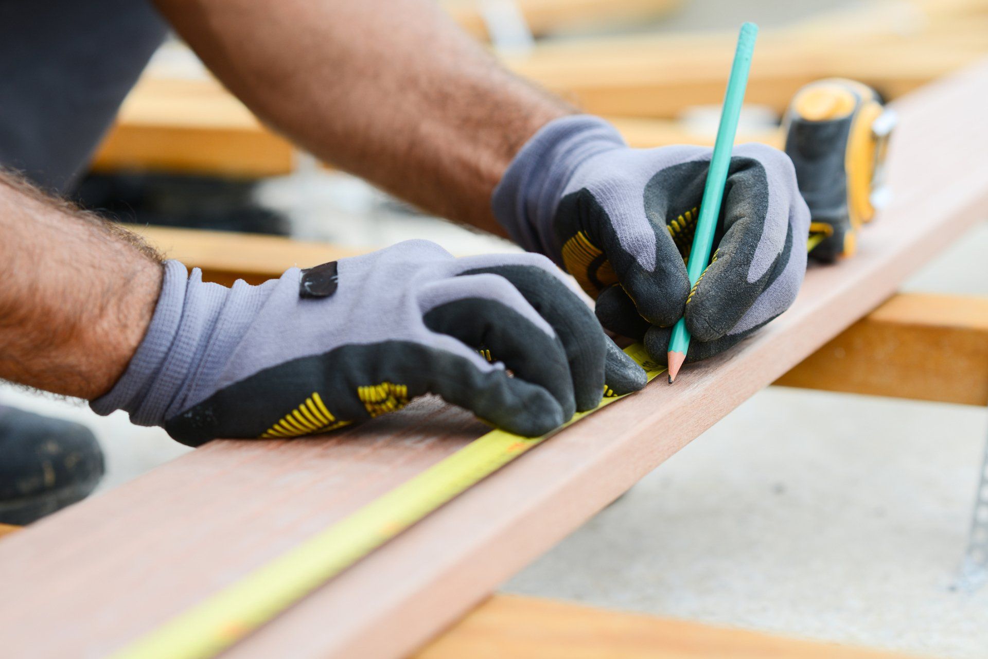 Carpenter Using Measuring Tape — Stock Island, FL — Key West Home Improvement and Painting Carpenter Using Measuring Tape — Stock Island, FL — Key West Home Improvement and Painting