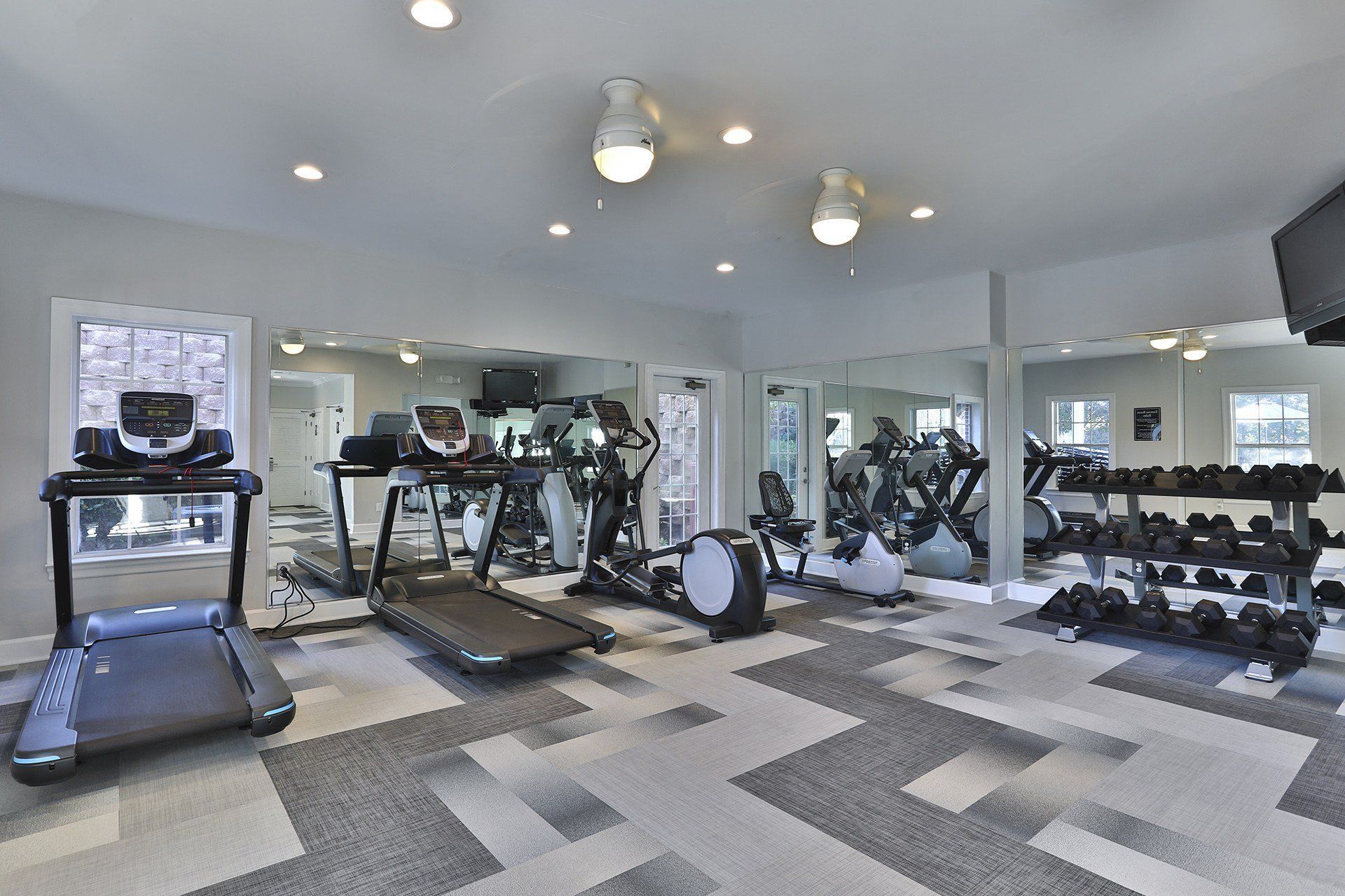 a gym with treadmills and other exercise equipment at Thornblade, Greenville, 29615