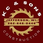 K & SONS CONSTRUCTION logo with flaming circular saw blade and Jefferson, WI phone number
