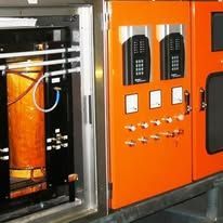 Orange industrial machine with a control panel and transparent chamber door open