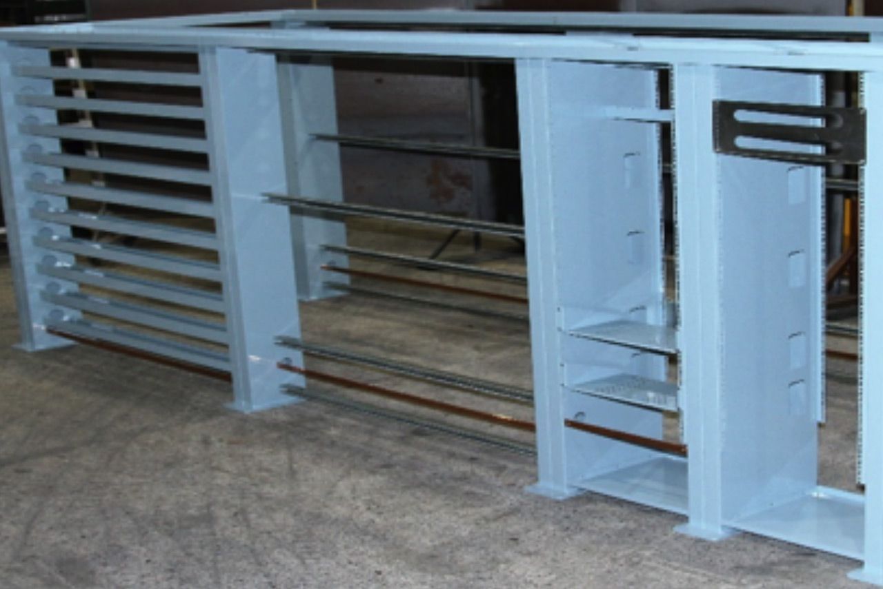 Blue metal turnstile gate with horizontal bars in an indoor entryway