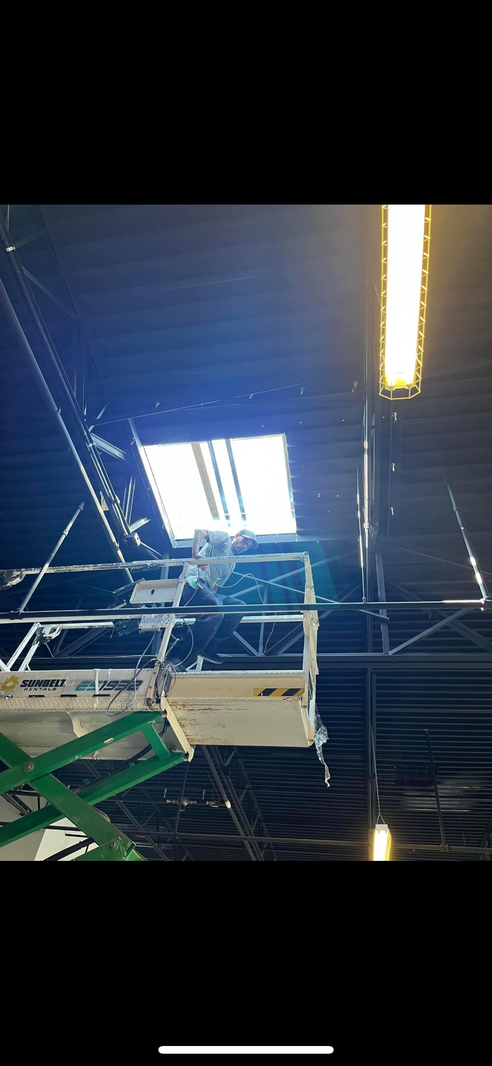 A person is working on a ceiling with a crane.