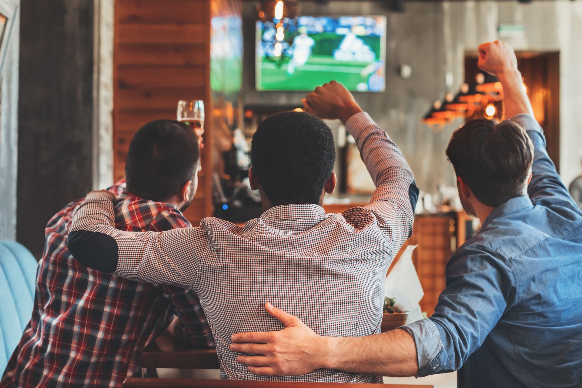 Three Men Watching Sports — Atlanta, GA — GQ's Bar B Que