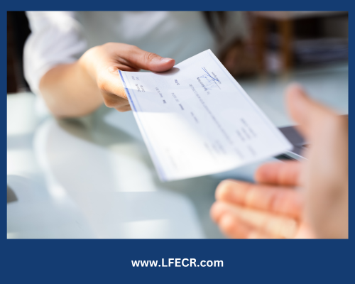 A person is handing a check to another person
