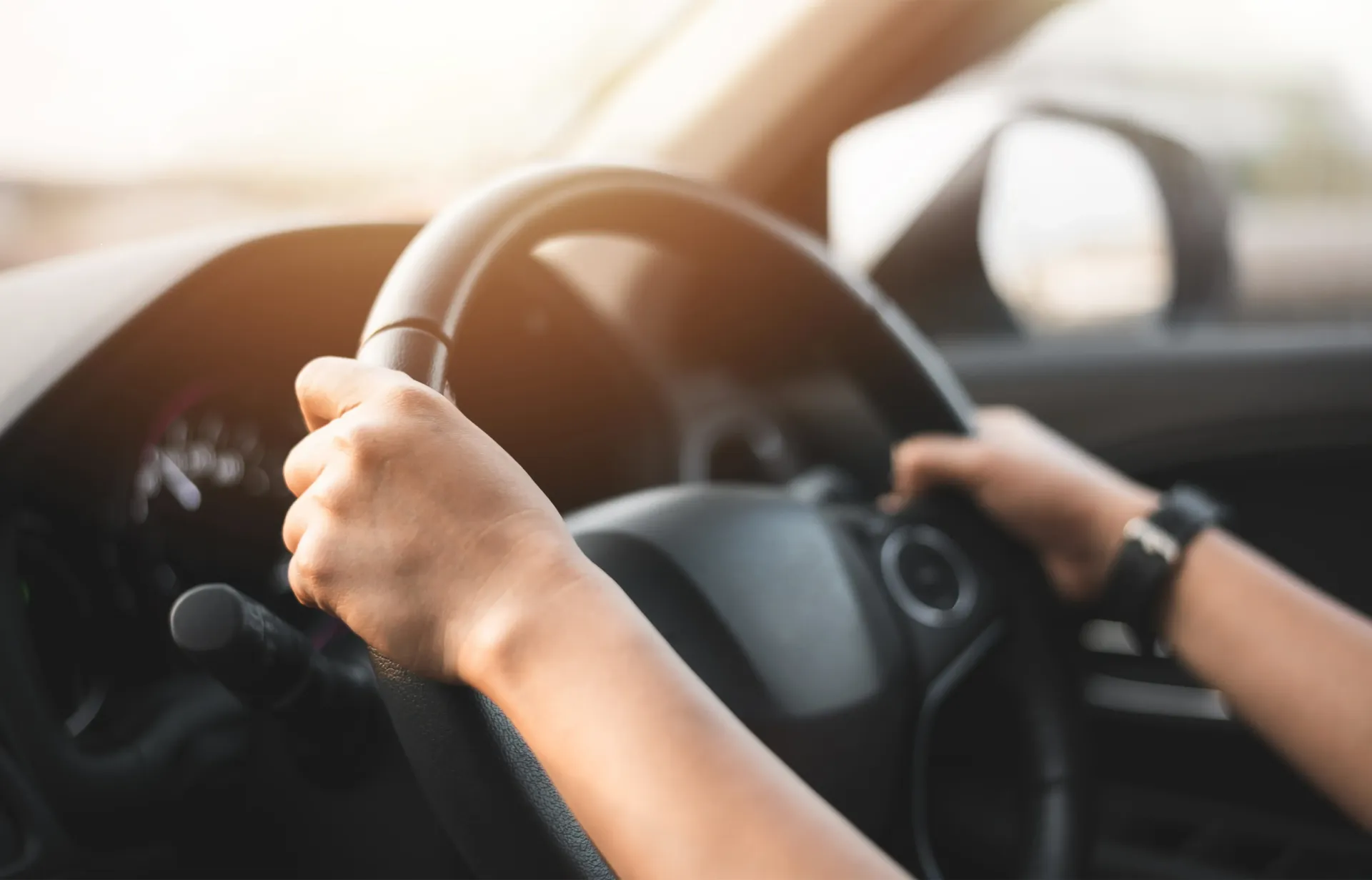 A person is driving a car. This law limits employers from requiring a driver's license from job applicants