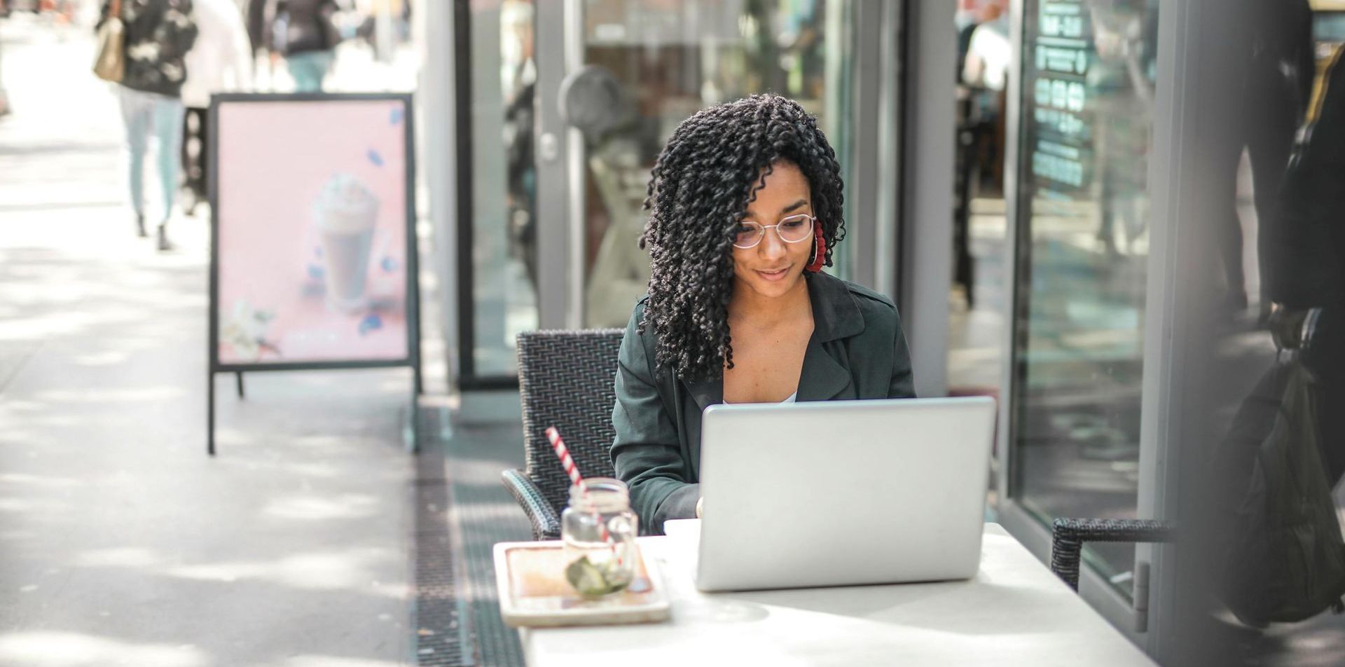 A freelancer is sitting at a table using a laptop computer.