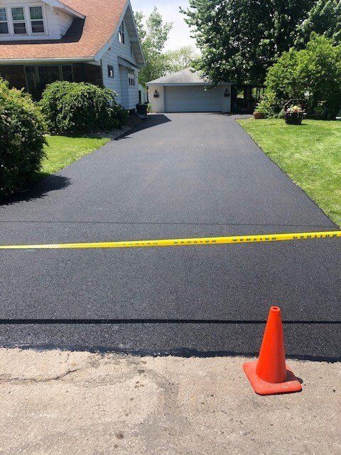 Installing Asphalt at The Home Driveways — Northwood, OH — D & D Paving Inc.