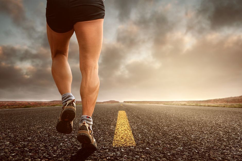 Runner's legs on a road, illustrating running and varicose veins, LEDAS sports and vein health guide
