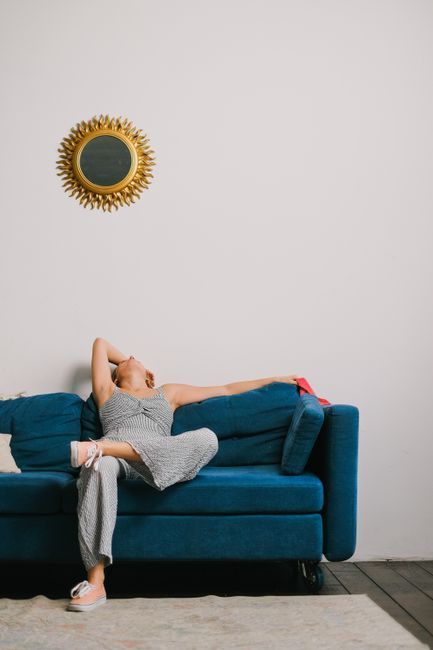 Person resting heavy, aching legs – a common varicose vein symptom explained by LEDAS