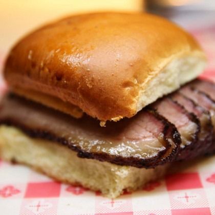 Close-up of a roast beef sandwich on a checkered paper tray