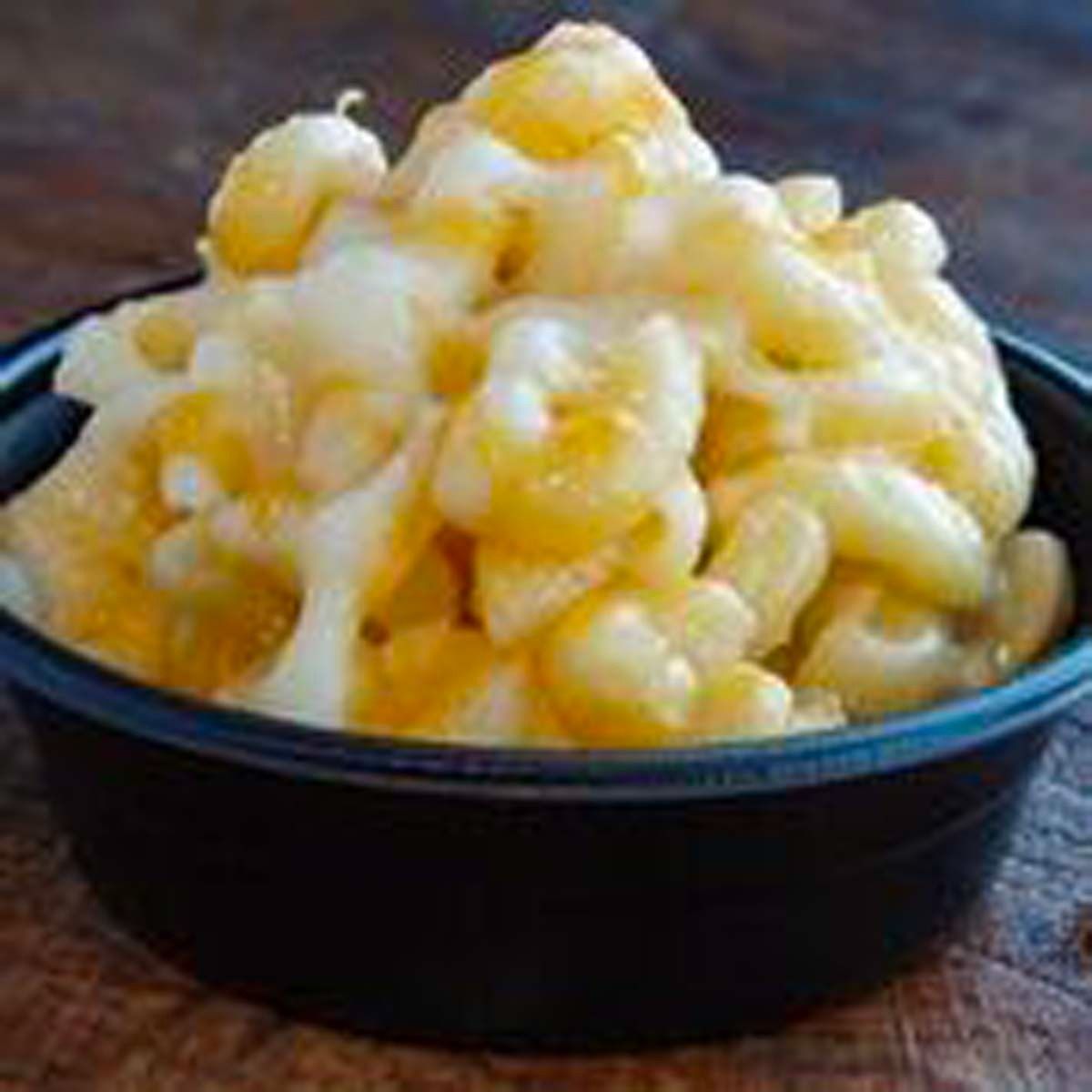 Bowl of creamy macaroni and cheese with golden melted cheese on top