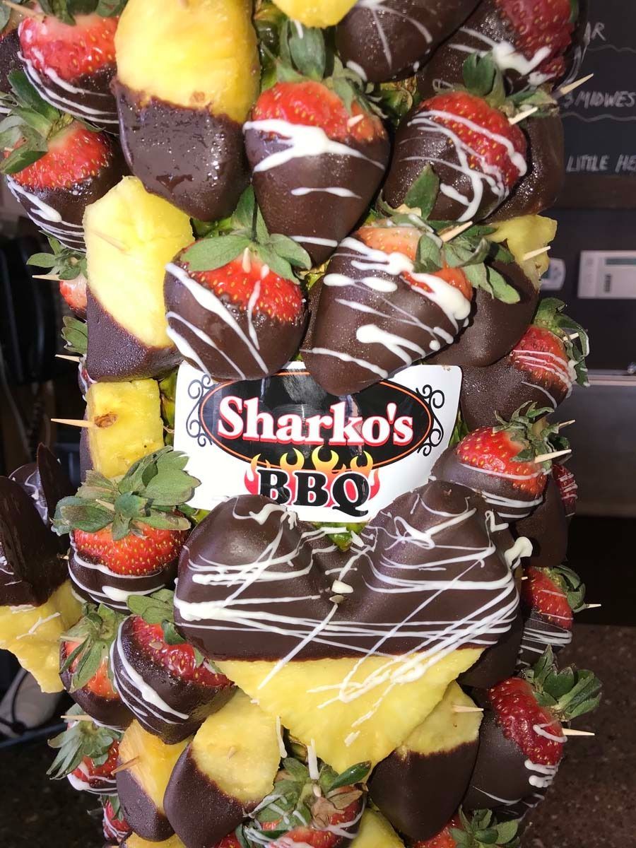 Chocolate-covered strawberry and pineapple display with Sharko’s BBQ sign