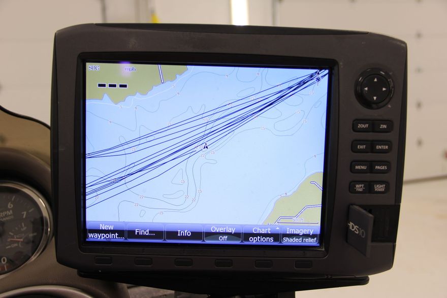 Marine GPS/chartplotter screen showing a nautical map with route lines in a black dashboard unit
