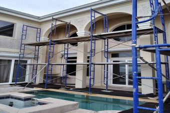 large home with scaffolding