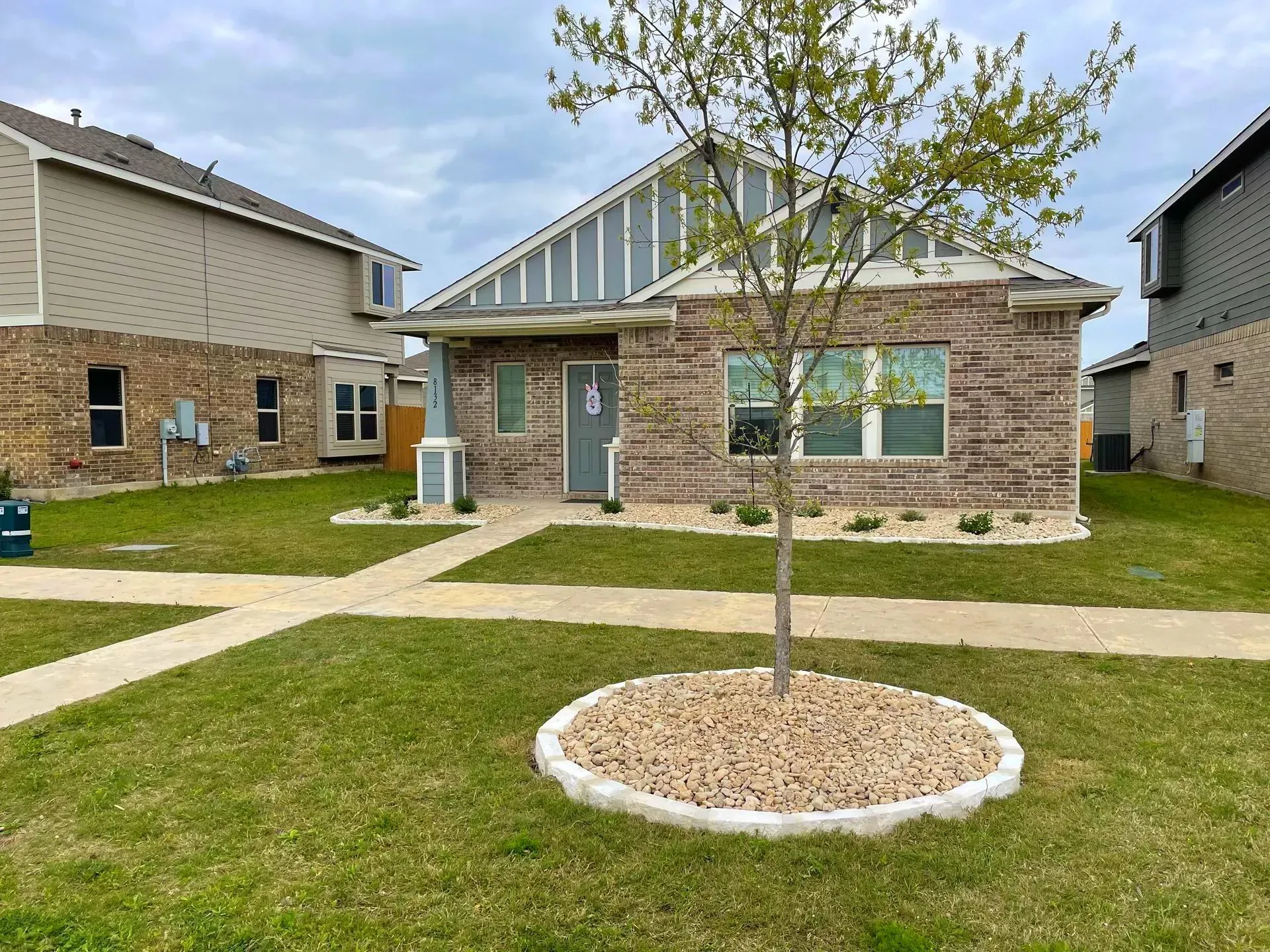 House with green lawn after Round Rock Lawn Care
