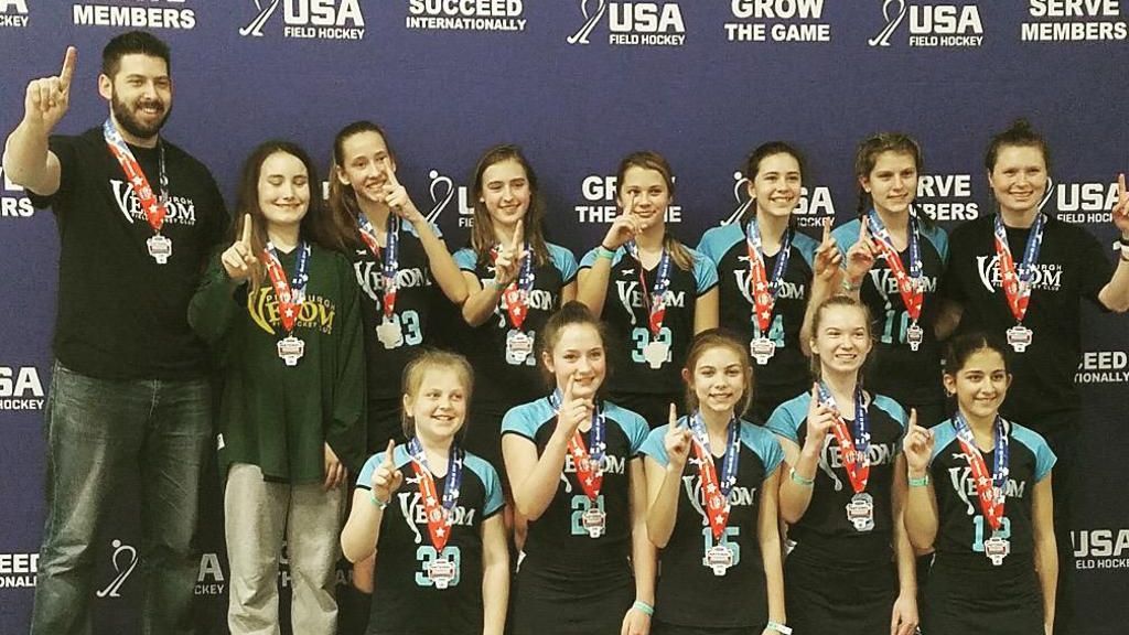 A group of athletes posing for a picture with a banner behind them that says serve members