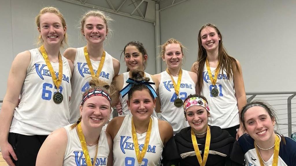A group of young women wearing medals are posing for a picture.