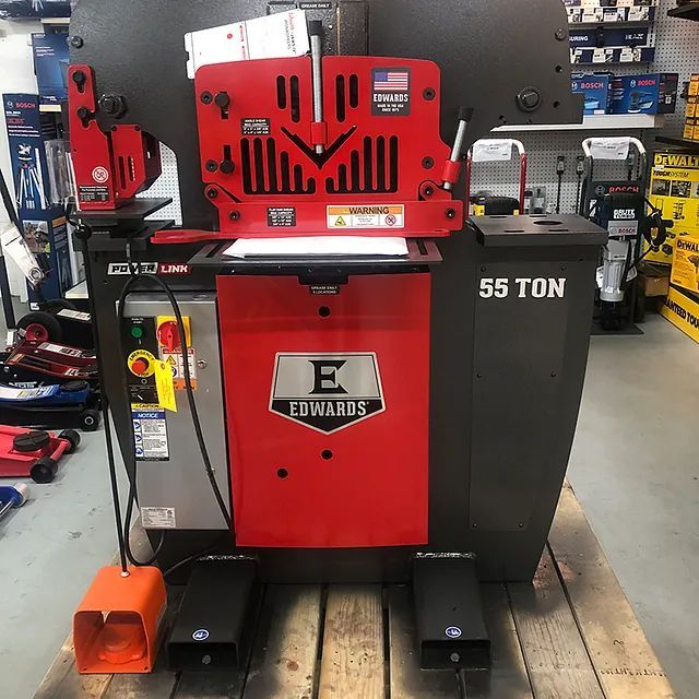 Red and black 55-ton Edwards industrial metalworking machine in a workshop.