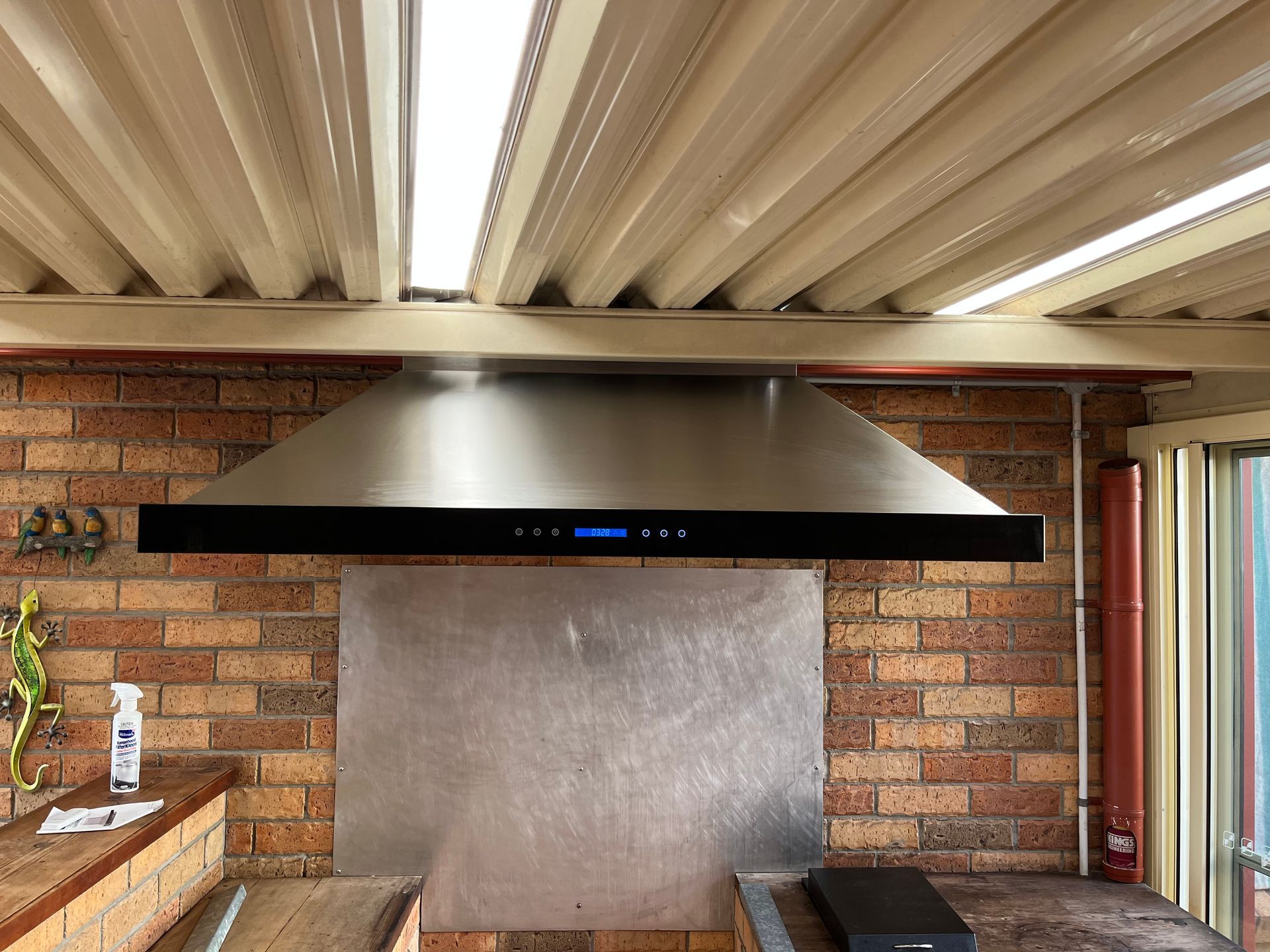 Patio With Black Range Hood Under a White Slatted Ceiling — Deltech HVACR in Georgetown, NSW