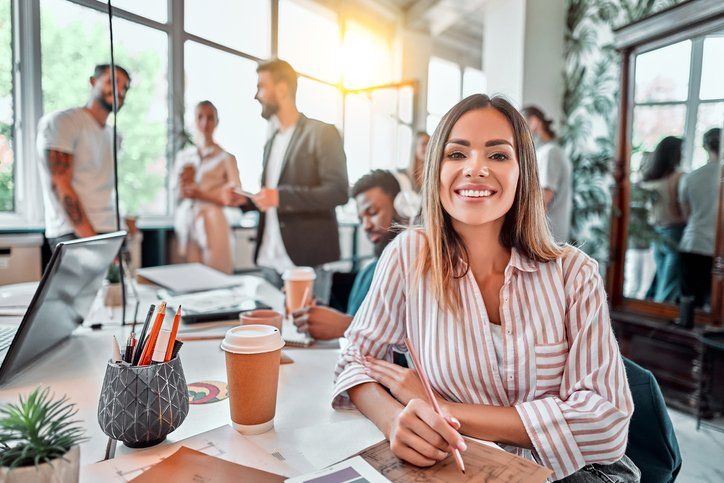 Smiling female employee sit in coworking space