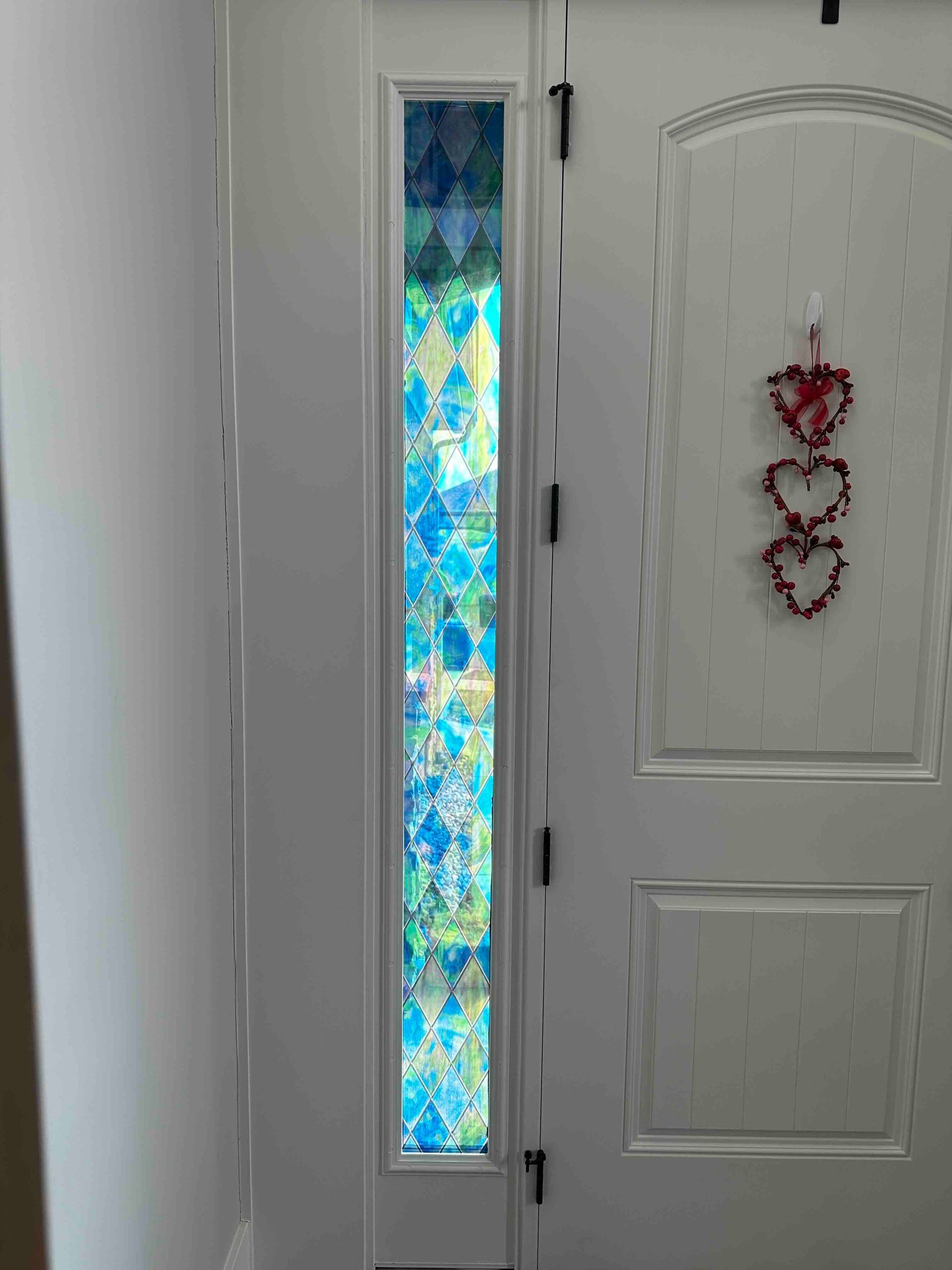 Frosted glass window panel with leaf design.